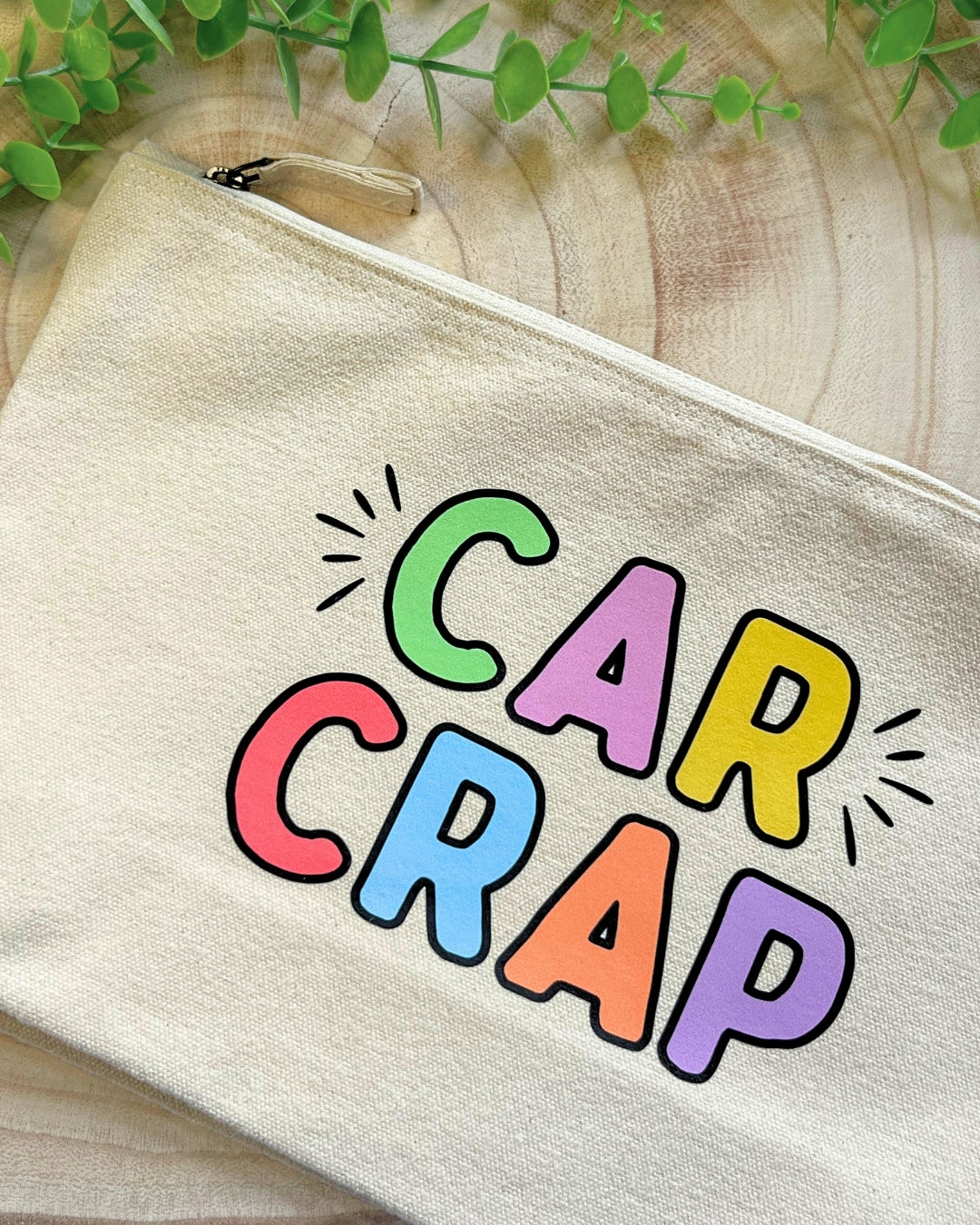 Large canvas zip pouch with bold, colourful “Car Crap” lettering