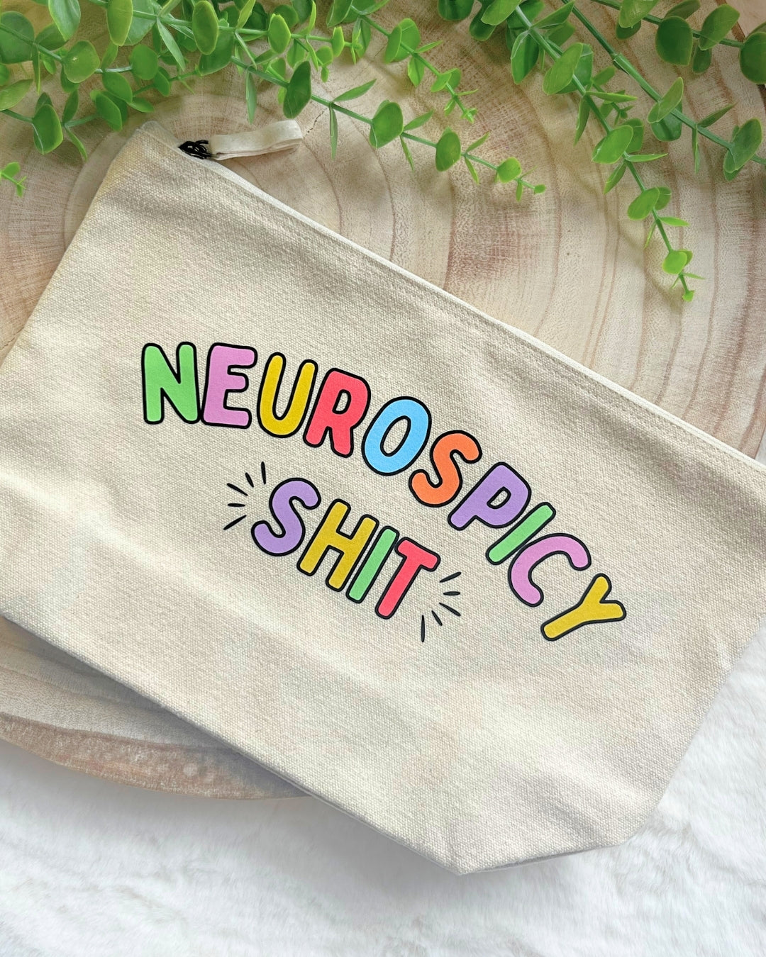 Beige zipper storage pouch with rainbow text design, perfect for fidgets, stationery, and makeup items.