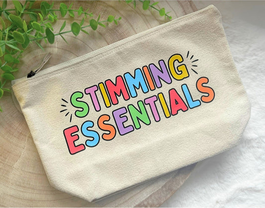 Beige pouch with 'STIMMING ESSENTIALS' text in colorful letters on a light background.