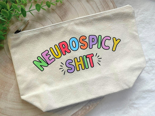 Canvas zip pouch with multicolor lettering “Neurospicy Shit,” durable bag for ADHD and autism essentials.